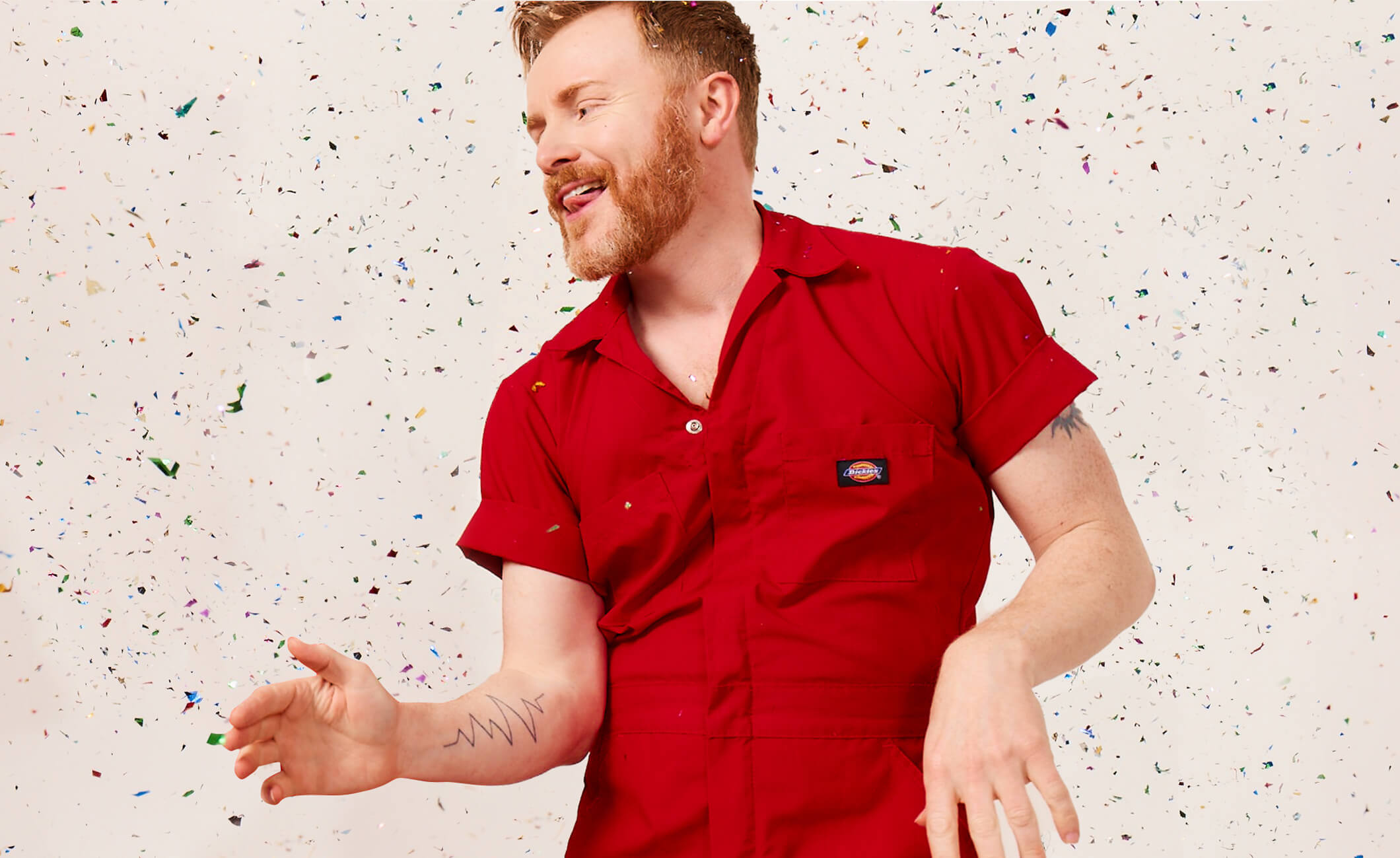 Man dancing in red shirt and speckled background