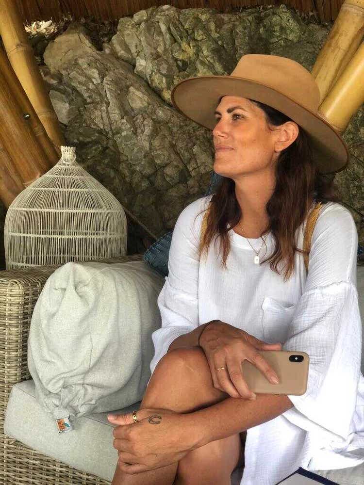 Digital nomad Tess Willcox sitting comfortably in an exotic location.