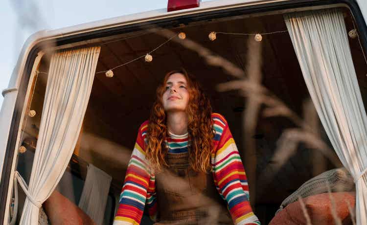 van-life-girl-smiling-looking-out-window--travelling