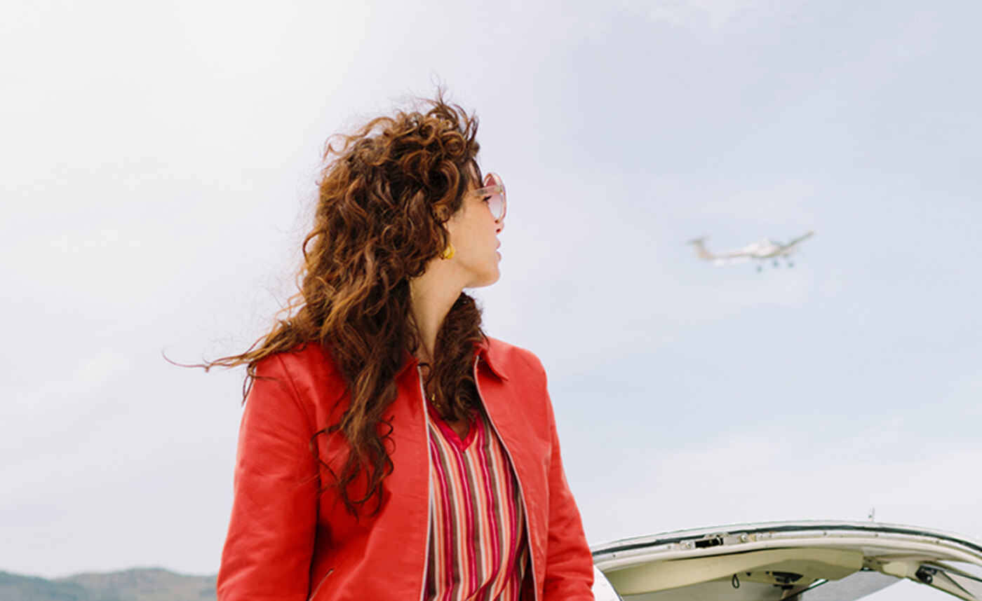 travel-budget-planning-woman-watching-planes-fly