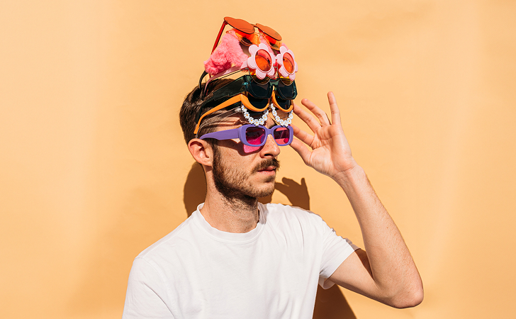 A person wearing multiple pairs of sunglasses he bought with his Virgin Money points