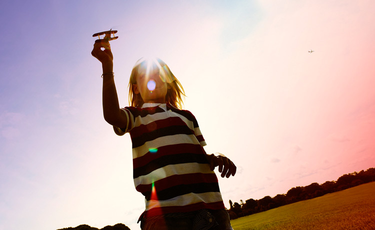 Kid playing with airplane